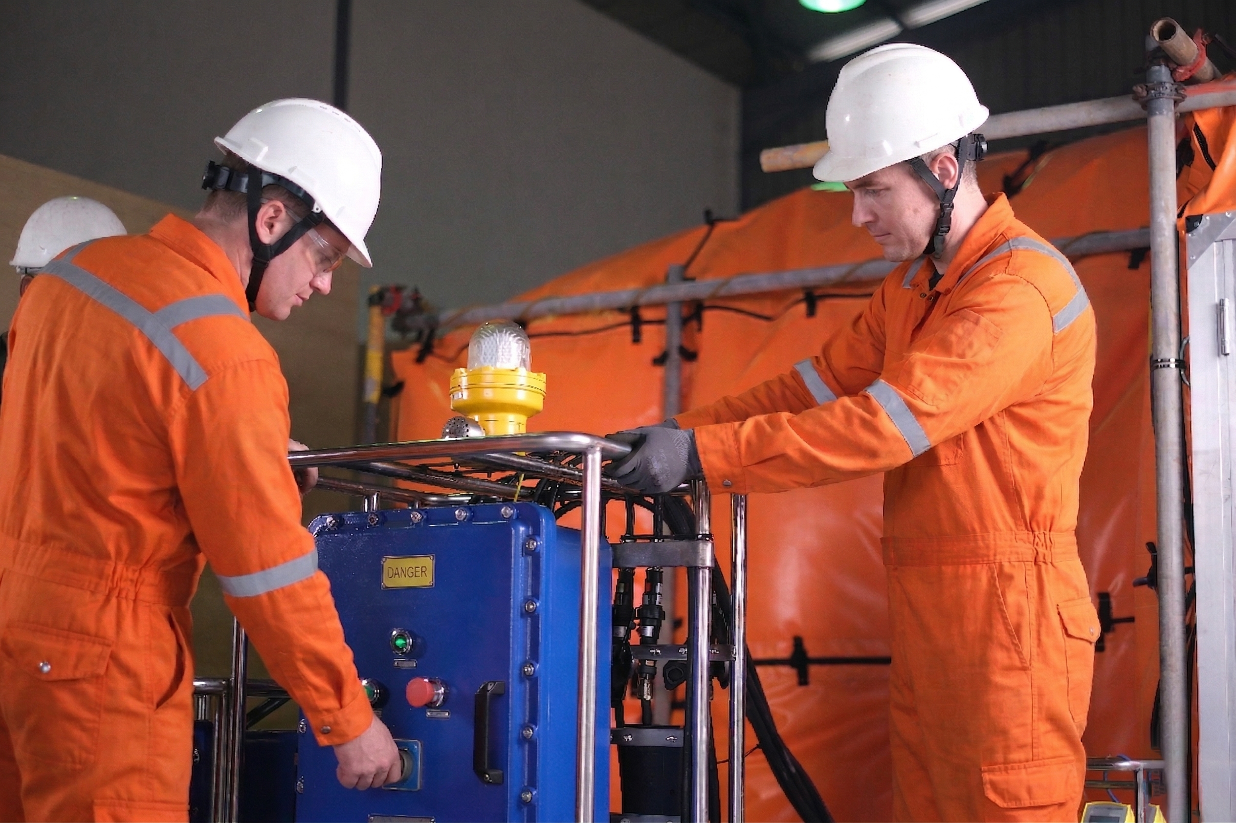 worker inspecting welding habitat system equipment for industrial safety compliance