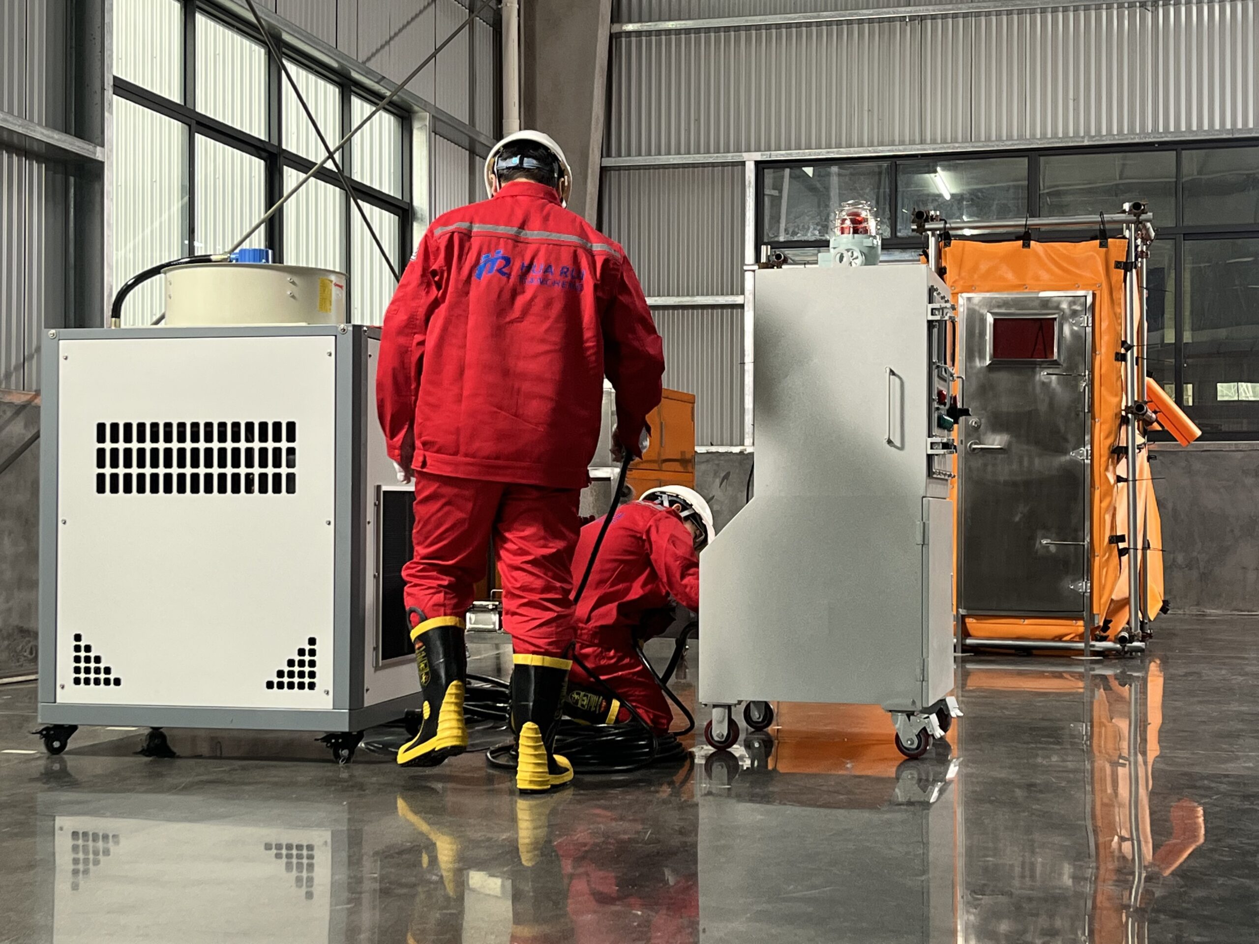 HSE manager inspecting a pressurized welding habitat system used for hot work safety in an industrial oil and gas facility.
